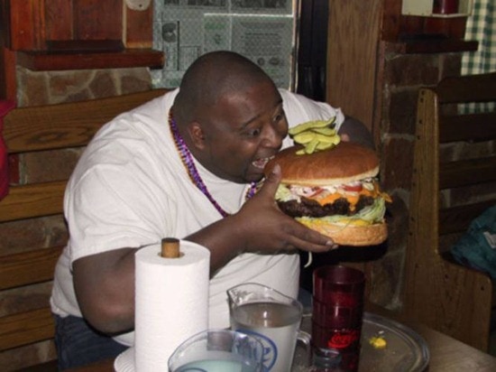 fat guy eating giant hamburger